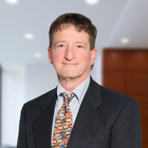 doctor in grey suite with multicolor tie